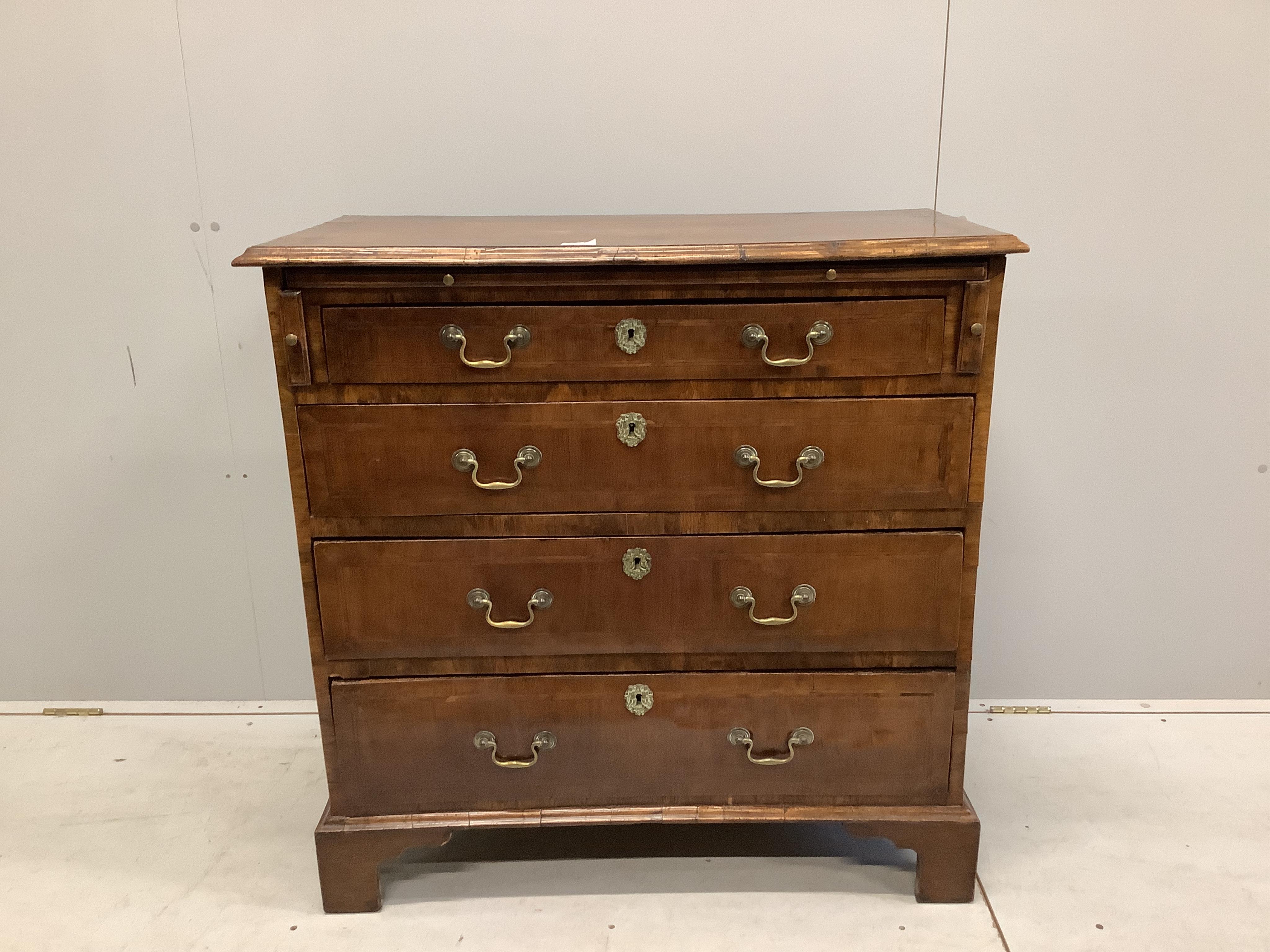 A mid 18th century feather banded walnut chest, fitted four long drawers, beneath a brushing slide, width 92cm, depth 48cm, height 92cm. Condition - fair